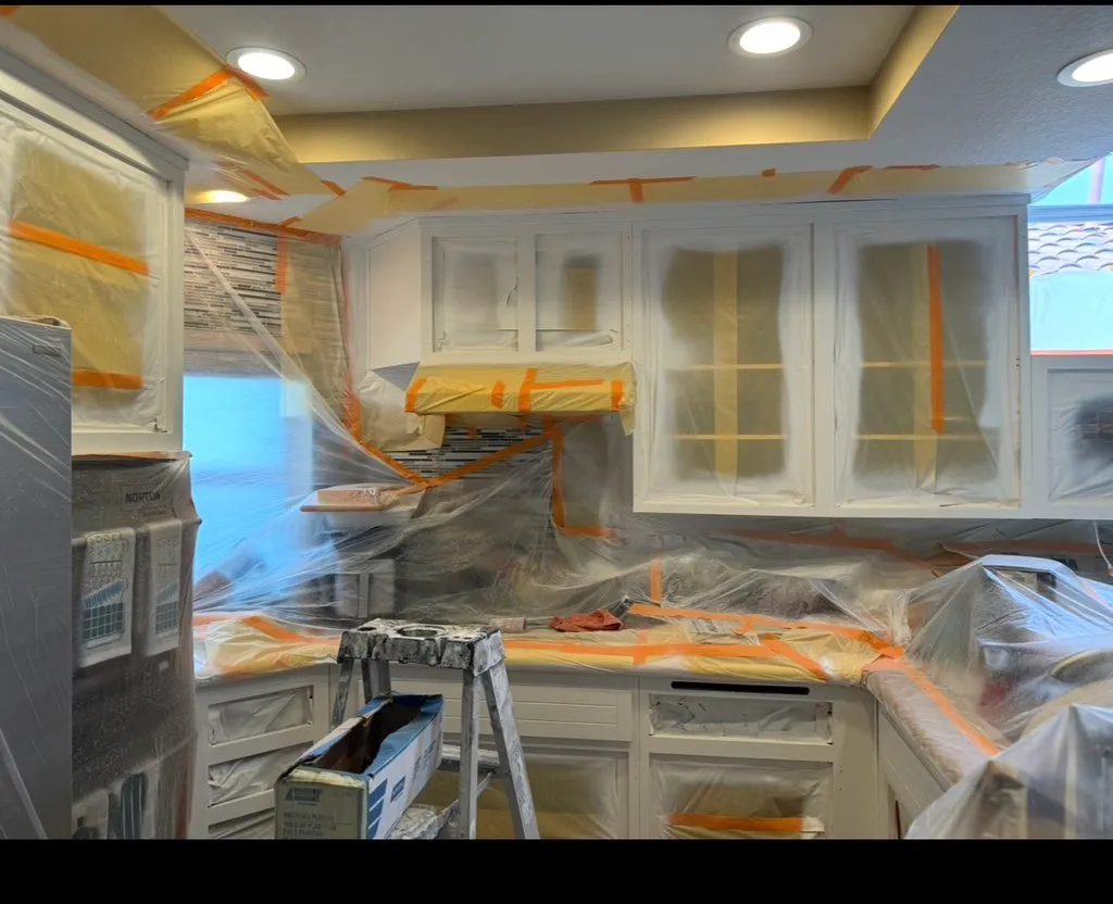 Kitchen cabinets being refinished during a JL Pro cabinet painting project